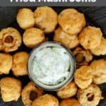 fried mushrooms and dipping sauce on a platter.