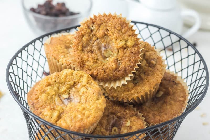 oatmeal raisin muffins with walnuts and coconut in a basket.