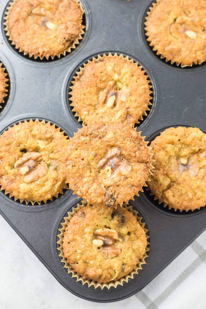 overhead view of homemade oatmeal raisin muffins in a muffin pan.