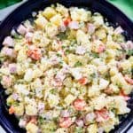 overhead view of olivier salad in a black serving bowl.