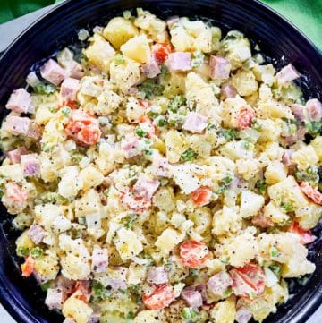 overhead view of olivier salad in a black serving bowl.