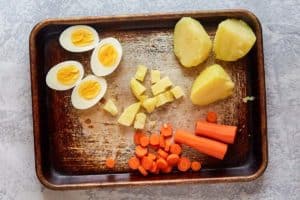 cooked potatoes, carrots, and eggs for olivier salad.
