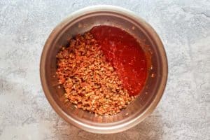 meat mixture and marinara sauce in a bowl.
