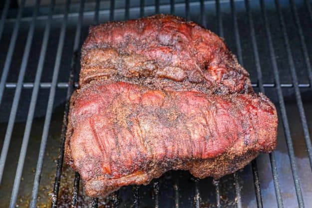 smoked pork belly on a smoker grate.