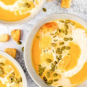 overhead view of pumpkin bisque in three bowls.