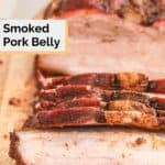 smoked pork belly on a wood cutting board.