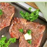 smoked steak and parsley on a tray.