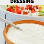 bowl of homemade blue cheese dressing with a spoon in it.