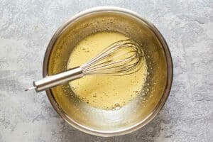 whipped eggs and sugar in a bowl.
