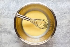 IHIP French toast batter and a whisk in a bowl.