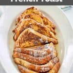 slices of IHOP French Toast with powdered sugar on a large plate.