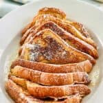 slices of homemade IHOP French Toast with syrup on a platter.