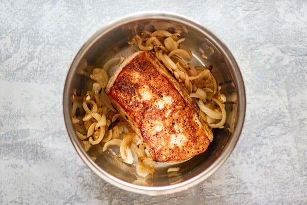 browned pork loin and cooked onions in an Instant Pot.