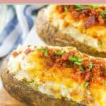 two loaded twice baked potatoes on a wood board.