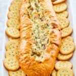 Mississippi Sin Dip and butter crackers on a long white platter.