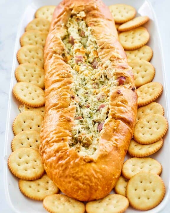 Mississippi Sin Dip and butter crackers on a long white platter.
