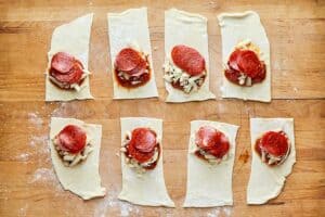 pepperoni pizza filling on top of small pizza dough rectangles.
