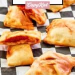 several pepperoni hot pockets on parchment paper.