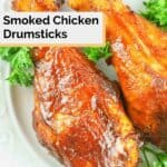 two smoked chicken drumsticks and parsley on a plate.