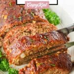 tongs holding a slice of smoked meatloaf over the meatloaf.