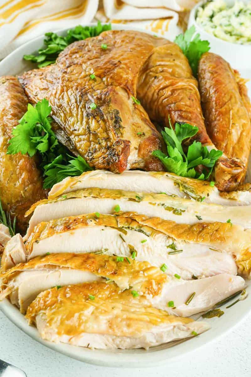 smoked spatchcock turkey slices and pieces on a platter.