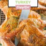 knife cutting into a smoked spatchcock turkey.