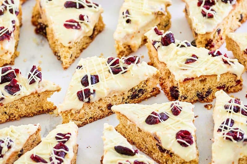 copycat Starbucks cranberry bliss bars on white parchment paper.