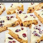 homemade Starbucks cranberry bliss bars scattered on parchment paper.