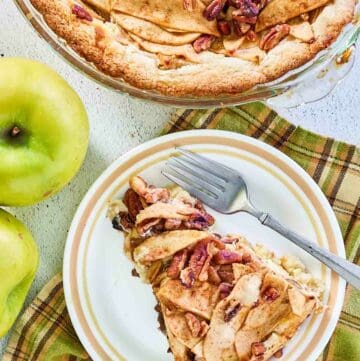 overhead view of apple pie cheesecake and a slice on a plate.