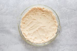 apple pie cheesecake crust in a pie pan.
