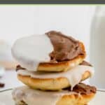 a stack of three black and white cookies.