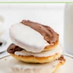 three black and white cookies on a plate.