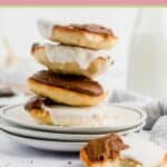 black and white cookies stacked on a plate and one next to them.
