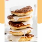 a stack of black and white cookies on a plate.