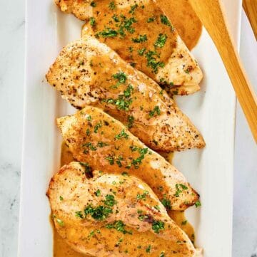 overhead view of chicken dijon and sauce on a platter.