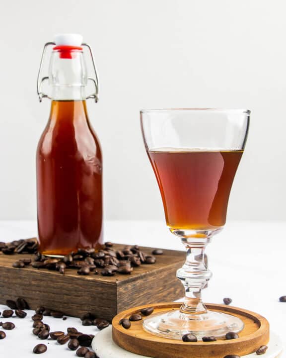 homemade Kahlua coffee liqueur in a glass and bottle.