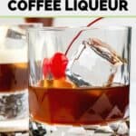 homemade Kahlua coffee liqueur in a glass with ice and a cherry.