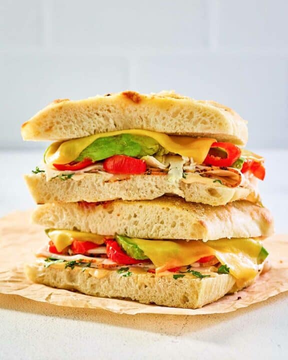 copycat Panera chipotle chicken avocado melt on parchment paper.