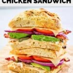 homemade Panera frontega chicken sandwich halves stacked on parchment paper.