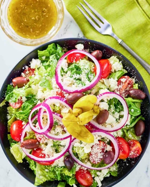 overhead view of copycat Panera Greek salad and dressing.