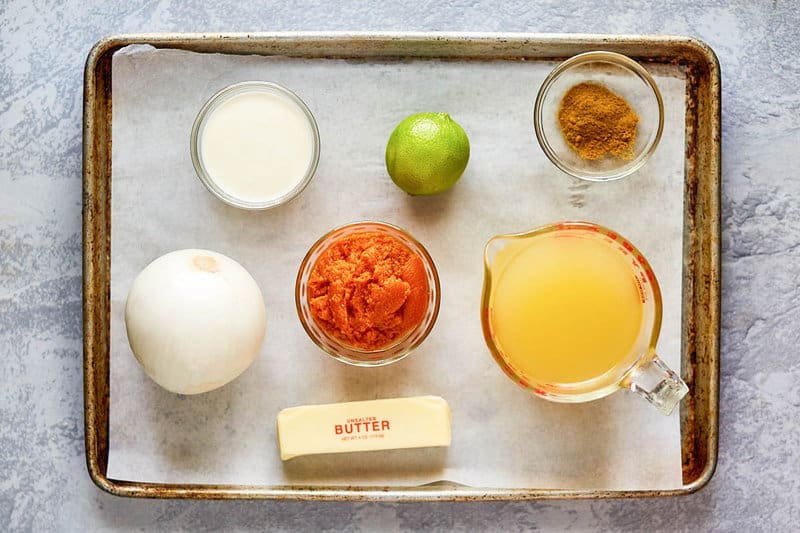 pumpkin curry soup ingredients on a tray.