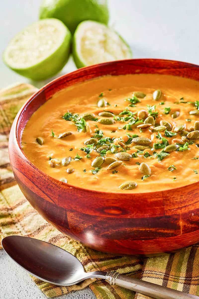 pumpkin curry soup topped with pumpkin seed kernels.