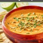 bowl of pumpkin curry soup and a spoon.