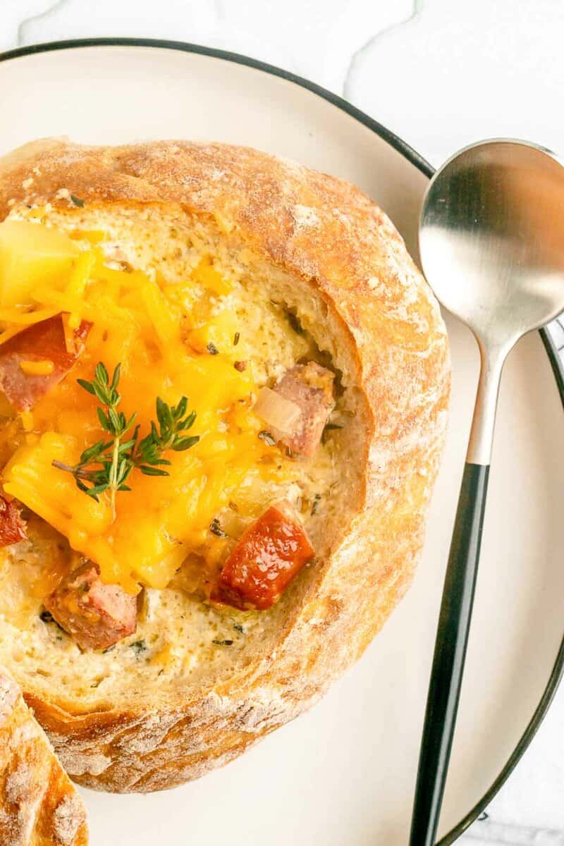 overhead view of sausage stew in a bread bowl.