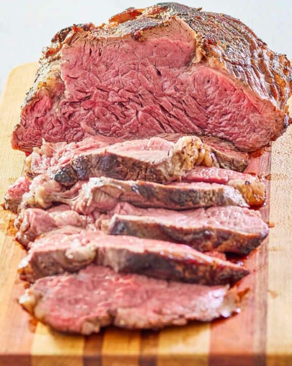 beef tenderloin roast on a wood cutting board.