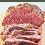 cooked beef tenderloin roast on a cutting board.