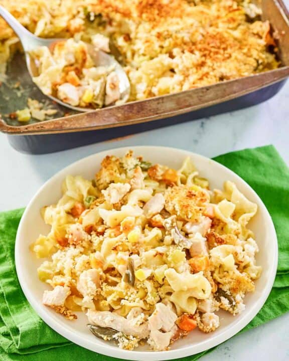 chicken noodle casserole on a plate and in a baking pan.