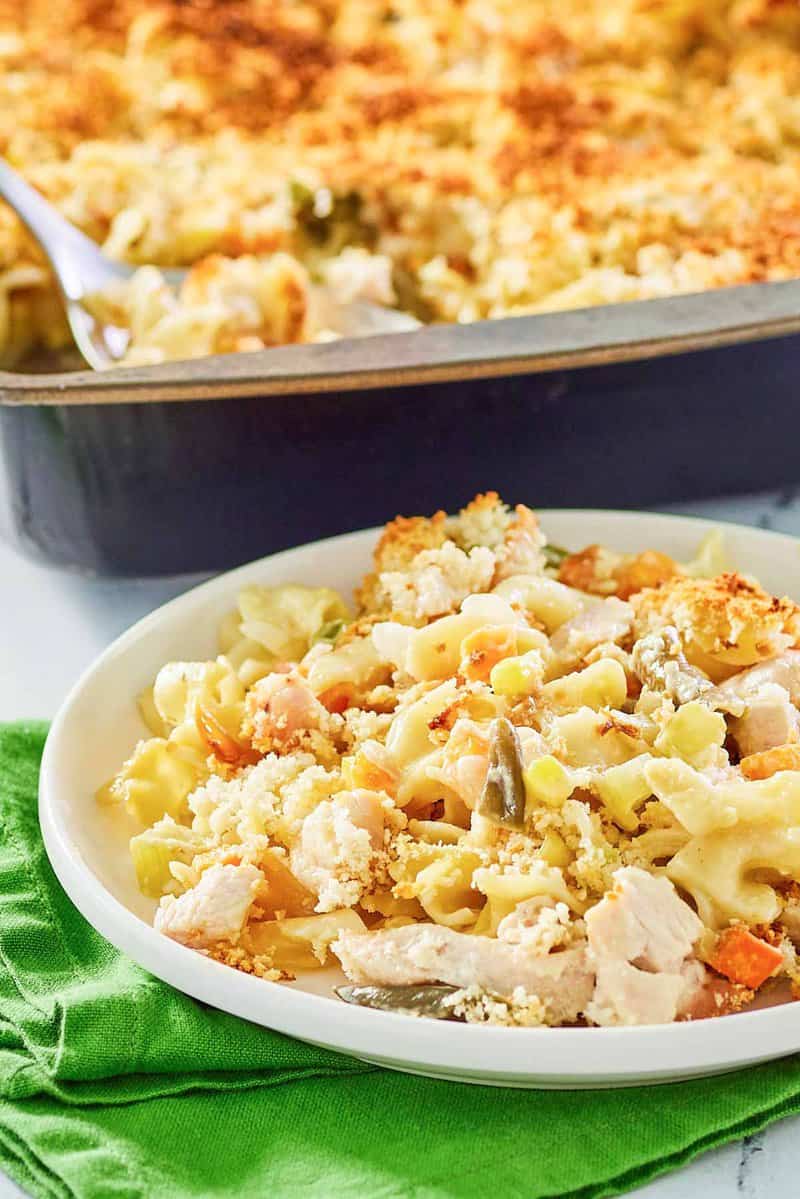 chicken noodle casserole on a plate and in a baking dish.