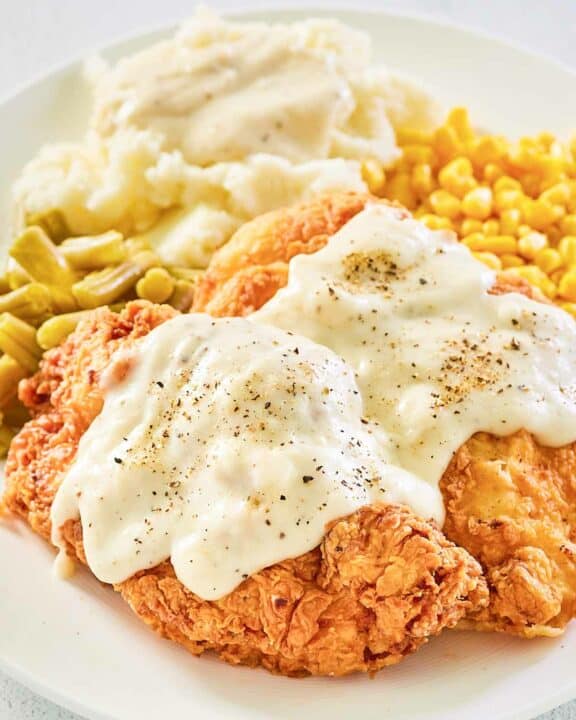 copycat Cracker Barrel chicken fried chicken with gravy on a plate.