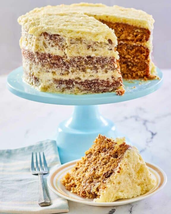 Hawaiian Cake on a blue cake stand and a slice on a plate.